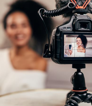 content marketing for startups - woman making a video and holding up her phone