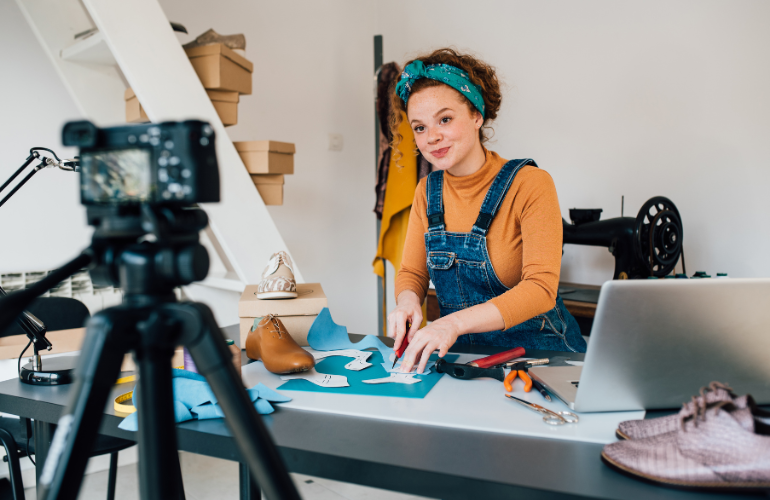 video storytelling for youtube marketing - woman working to craft leather goods while filming a video